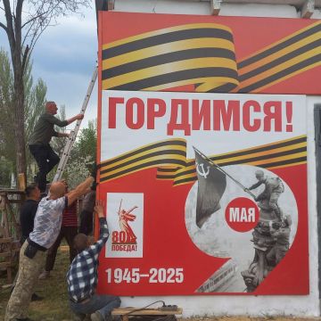 Специалисты из ЕАО украсили здание Амвросиевки баннерами с символикой 80-й годовщины Победы